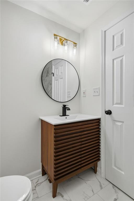 6807 Tralee Drive Lithia Springs, GA 30122 - Photo 26 of 36 a bathroom with a sink a mirror and toilet
