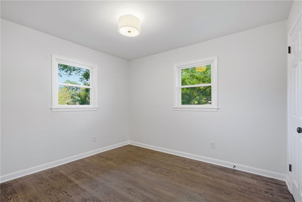6807 Tralee Drive Lithia Springs, GA 30122 - Photo 30 of 36 an empty room with wooden floor and window