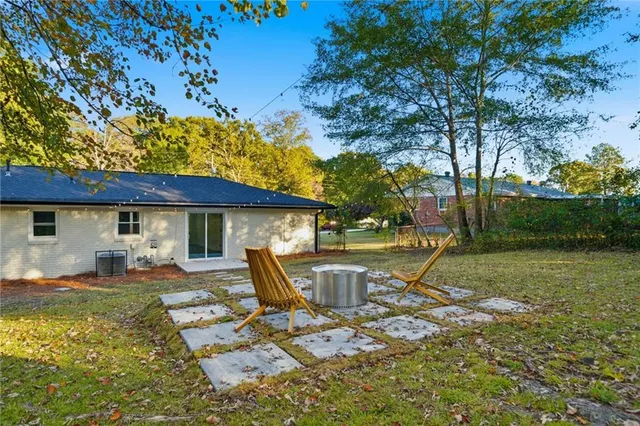 a view of a yard with a house in the background