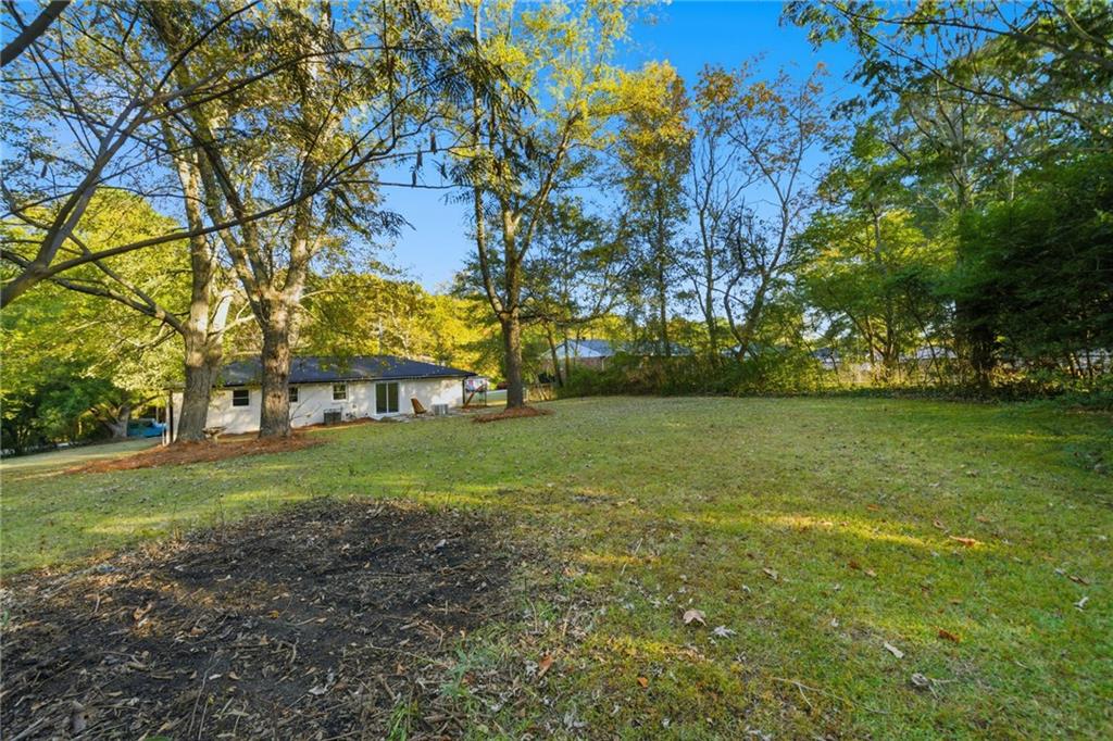6807 Tralee Drive Lithia Springs, GA 30122 - Photo 35 of 36 a view of a yard with a house in the background