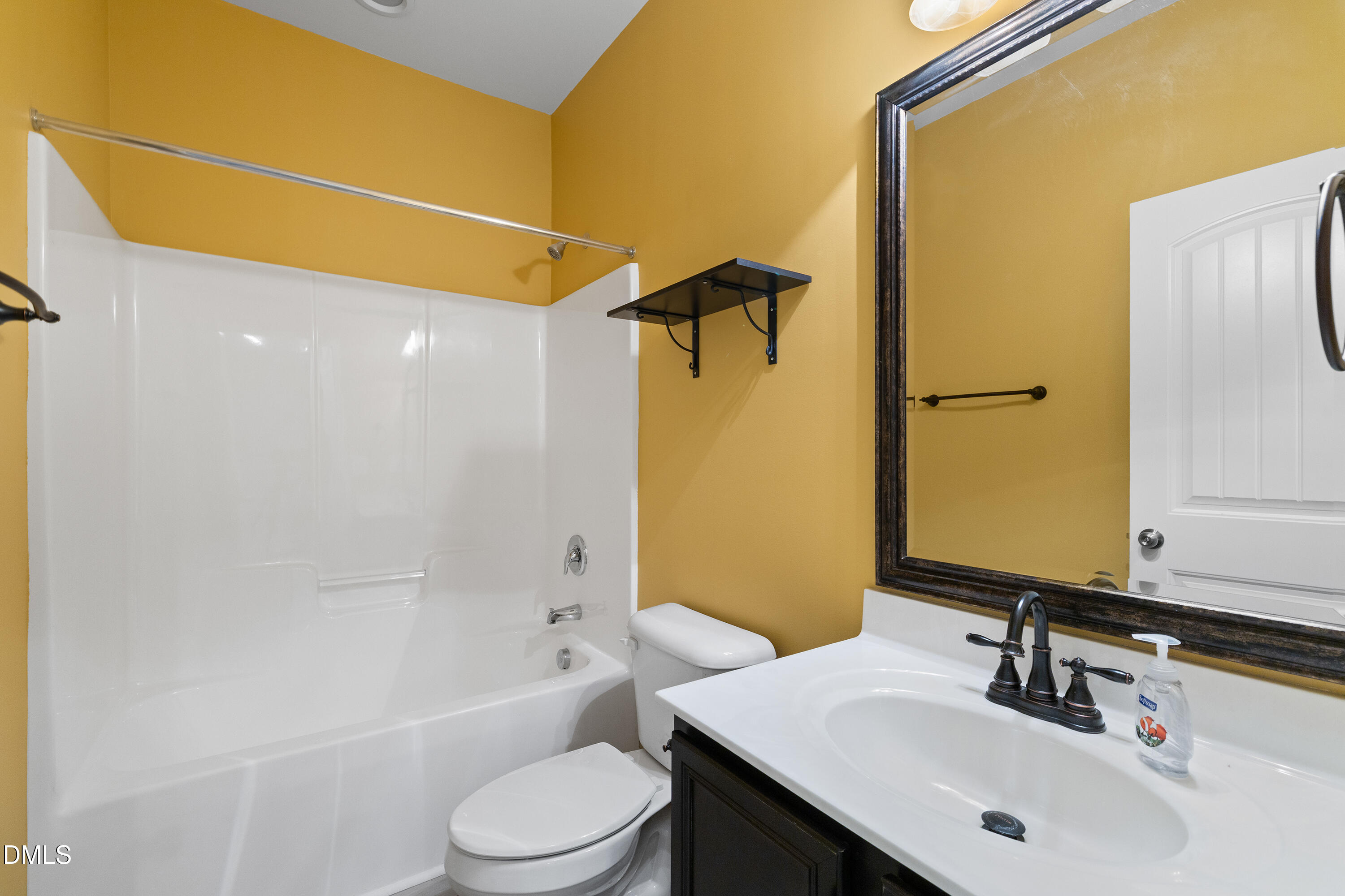 396 Naples Lane Clayton, NC 27527 - Photo 13 of 33 a bathroom with a sink a toilet and shower