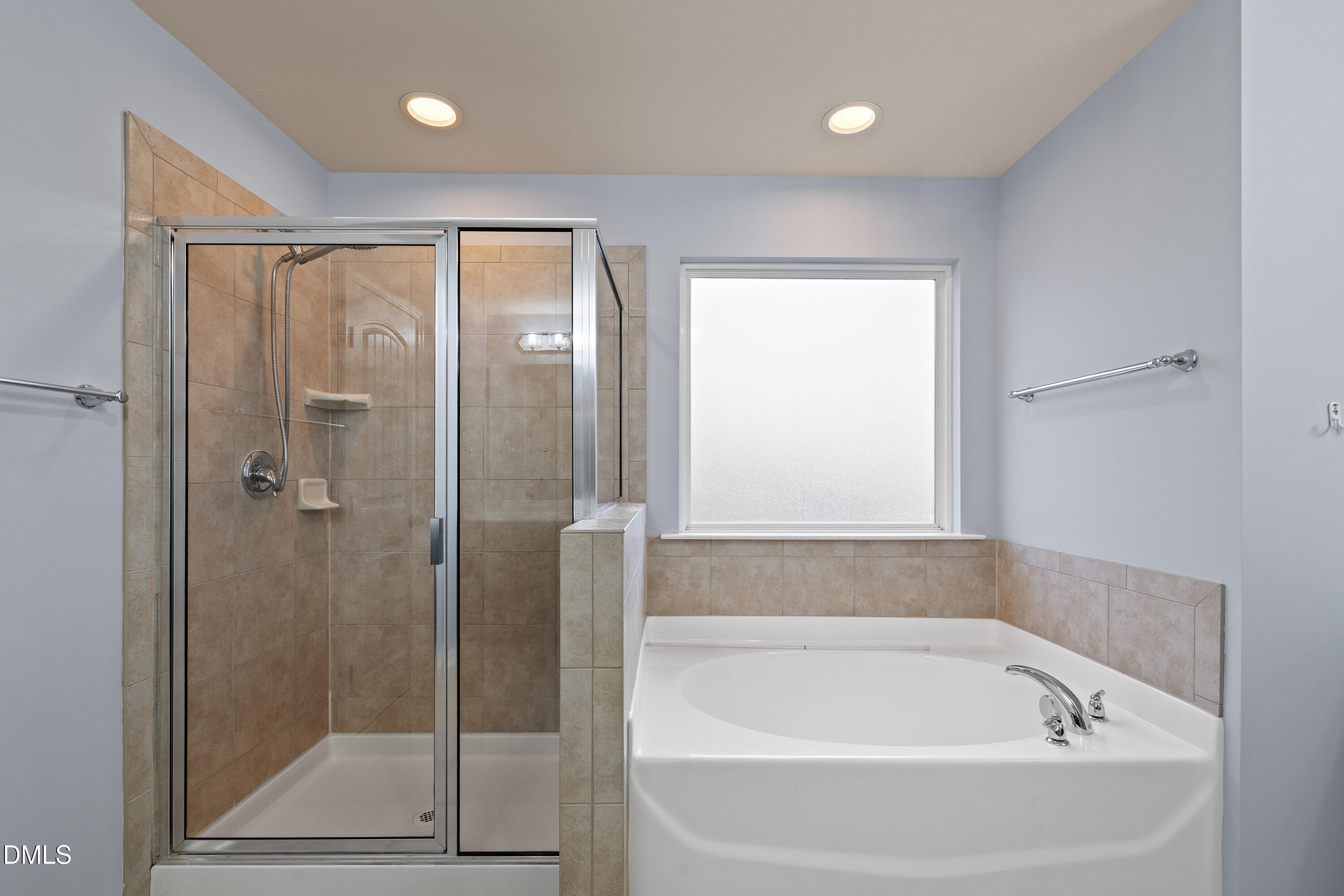 396 Naples Lane Clayton, NC 27527 - Photo 19 of 33 a bathroom with a bathtub and a shower
