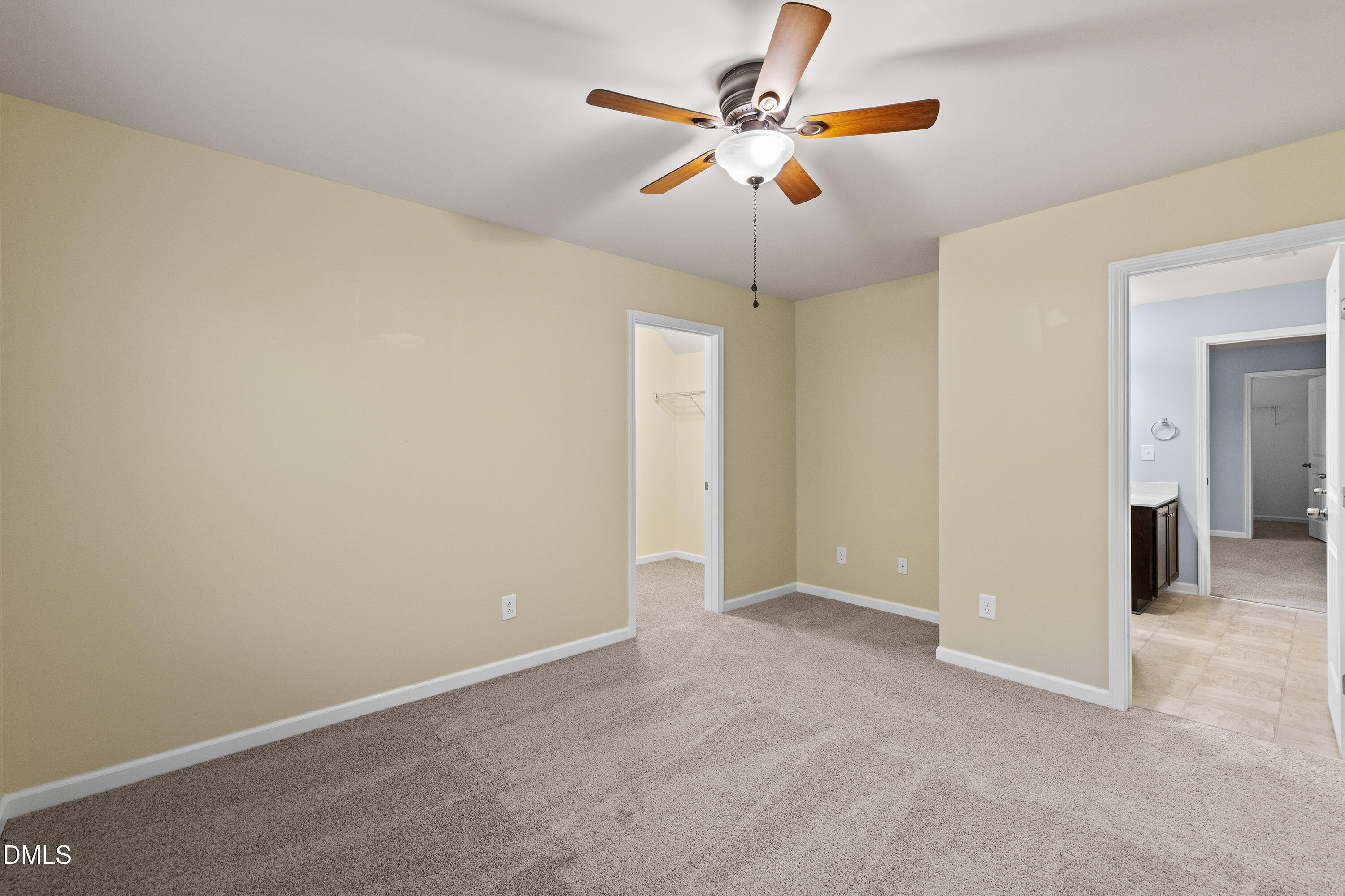 396 Naples Lane Clayton, NC 27527 - Photo 23 of 33 an empty room with a chandelier fan and a ceiling fan