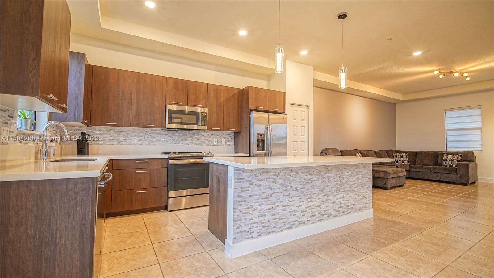 a large kitchen with kitchen island granite countertop a large counter top and stove