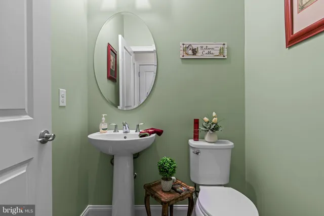 a bathroom with a sink mirror and toilet