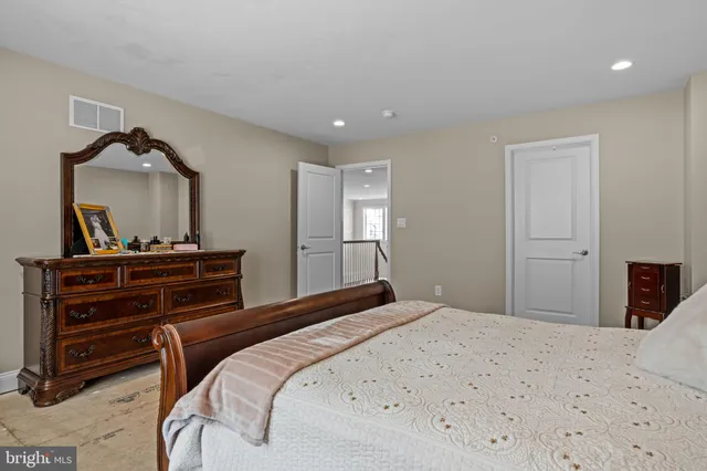 a bedroom with a bed and a dresser