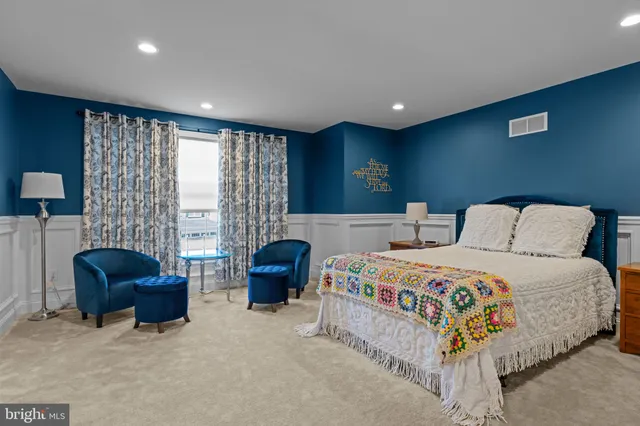 a bed room with a bed and a chair