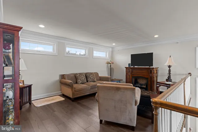 a living room with furniture and a painting on the wall