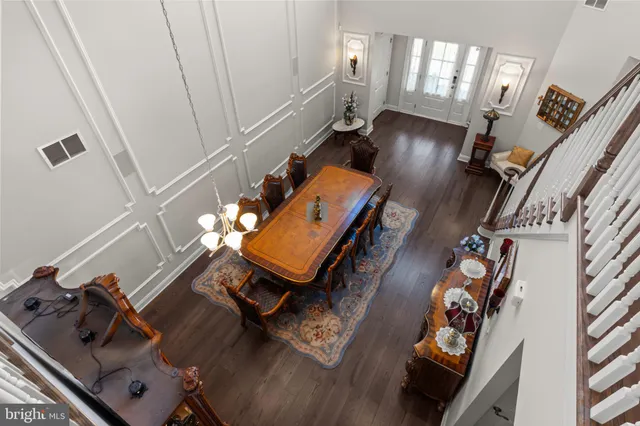 a view of a hallway with wooden floor and closet