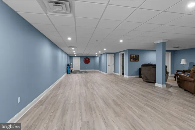 a bathroom with a granite countertop toilet sink shower and mirror