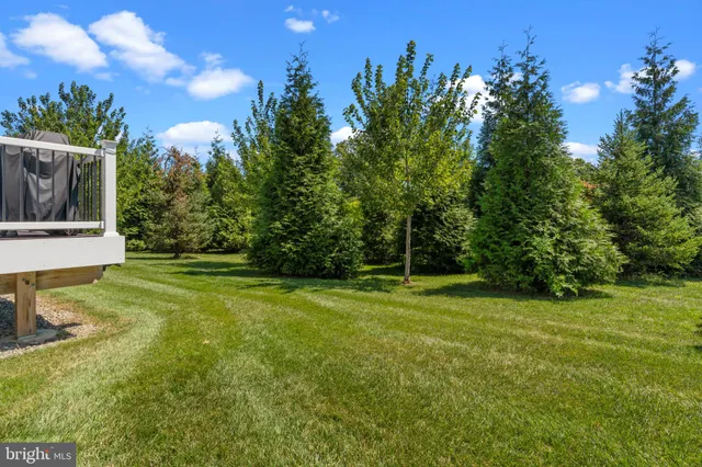a front view of a house with a yard and balcony