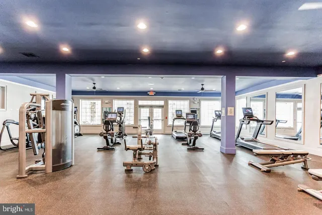 a living room with stainless steel appliances kitchen island granite countertop furniture and a dining table