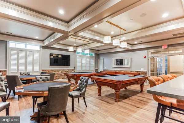 a living room with furniture a chandelier and a large window