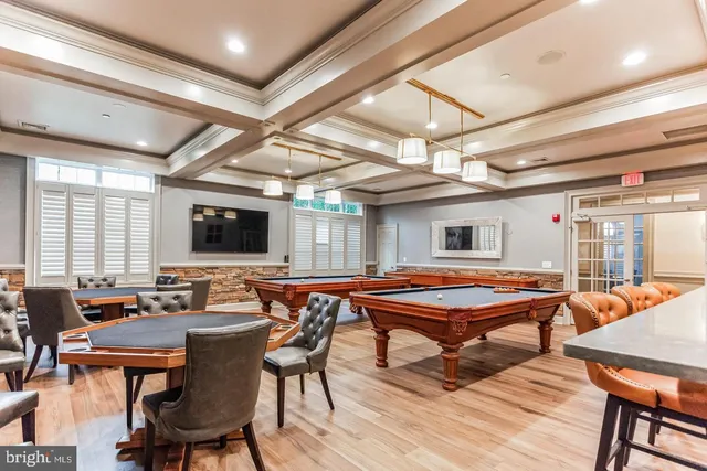 a living room with furniture a chandelier and a large window