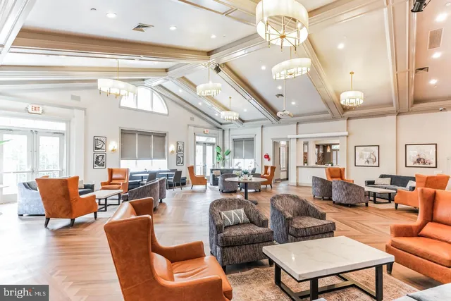 a living room with lots of furniture and a large window