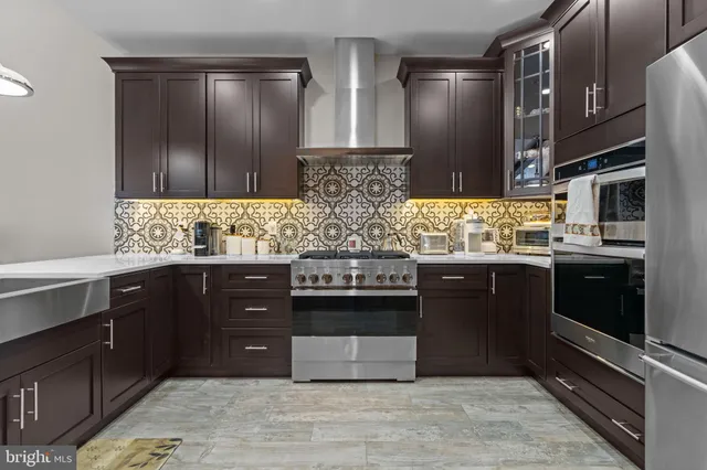 a kitchen with stainless steel appliances granite countertop wooden cabinets and a sink