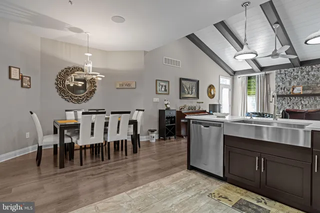 a large kitchen with lots of counter space and chandelier