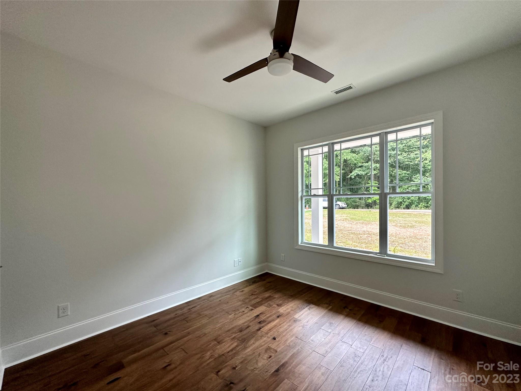 1427 Oak Park Road Rock Hill, SC 29730 - Photo 19 of 29 a view of an empty room with wooden floor and a window