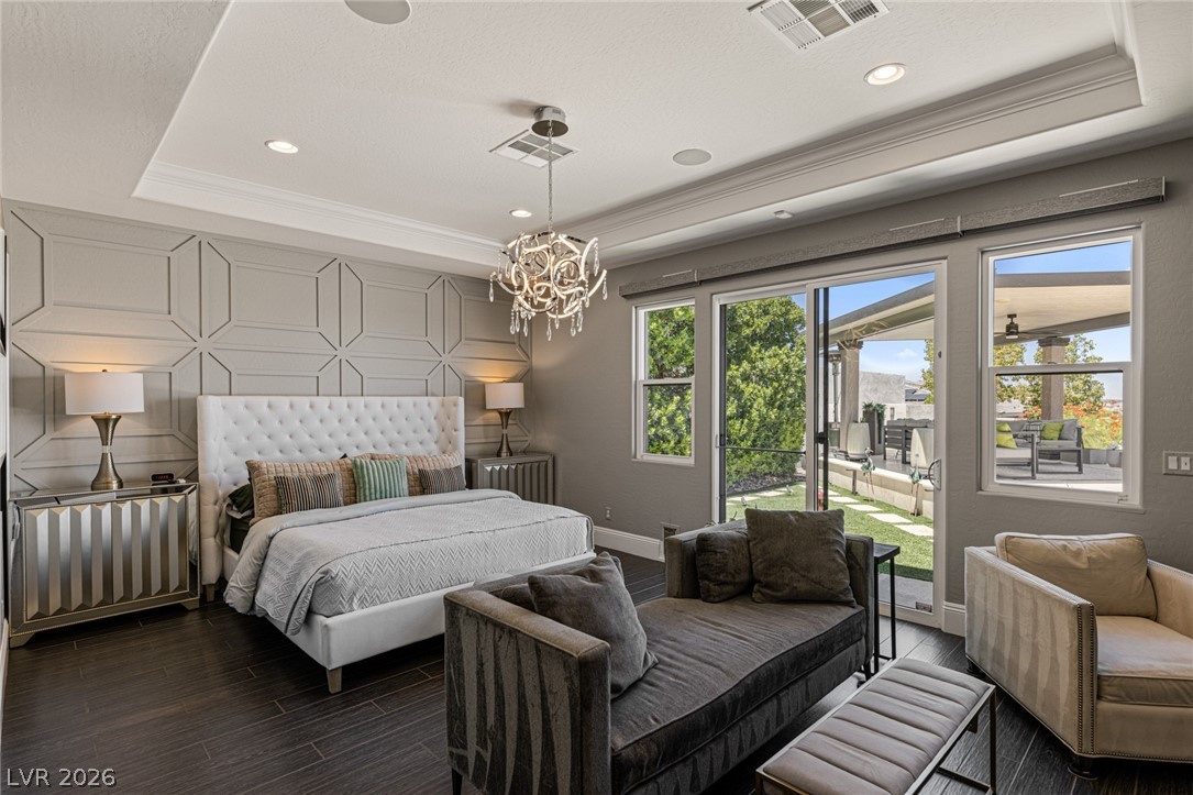 10118 Copper Edge Road Las Vegas, NV 89148 - Photo 12 of 48 Elegant primary bedroom offering direct access to an outdoor patio, perfect for enjoying serene mornings.