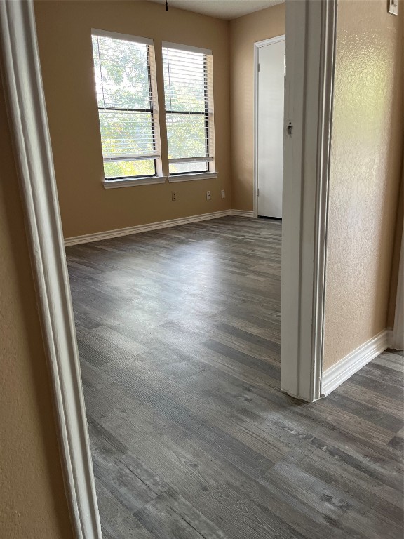 8500 Lyndon Lane, Unit B Austin, TX 78729 - Photo 19 of 22 an empty room with wooden floor and windows