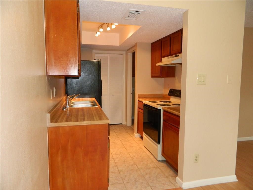8500 Lyndon Lane, Unit B Austin, TX 78729 - Photo 7 of 22 a kitchen with a stove and a refrigerator