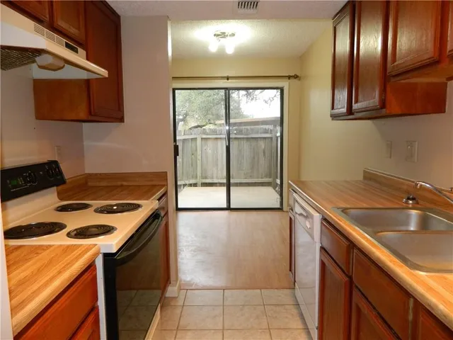 a kitchen that has a sink and a stove