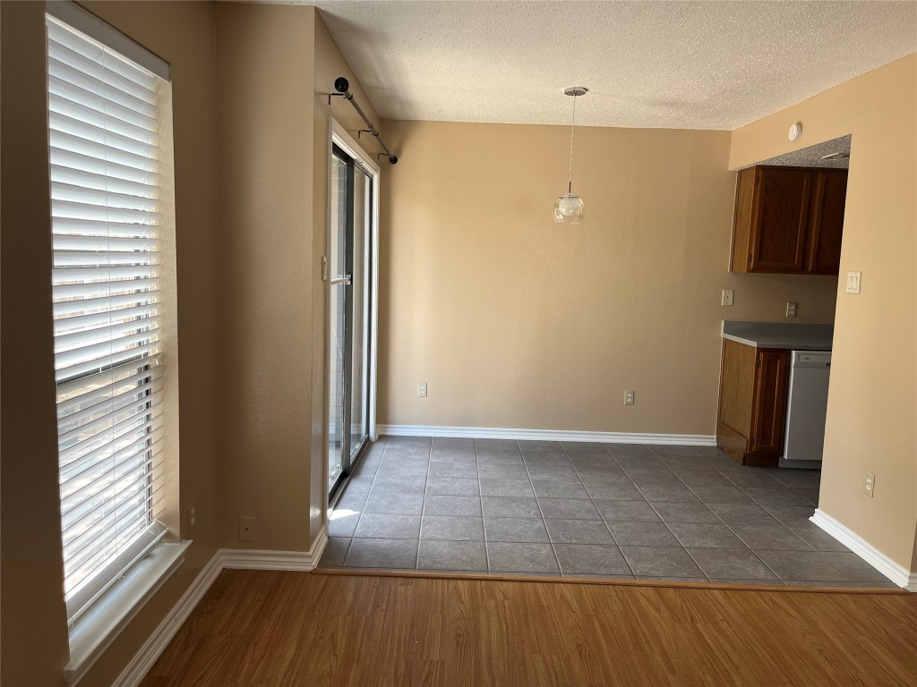 8500 Lyndon Lane, Unit B Austin, TX 78729 - Photo 10 of 22 an empty room with wooden floor and a window