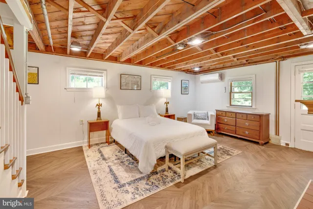 a spacious bedroom with a bed and a view of bathroom