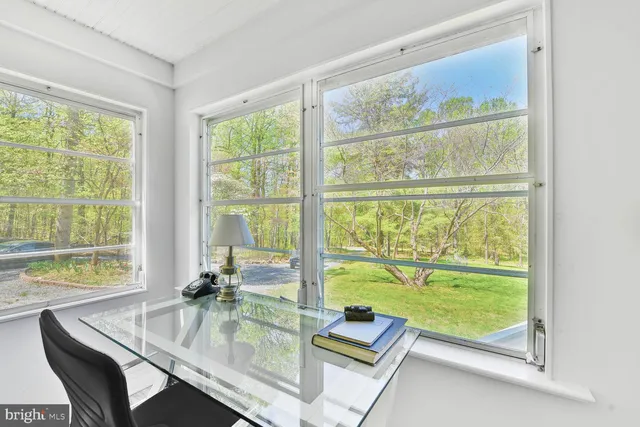 a dining room with a large window and table