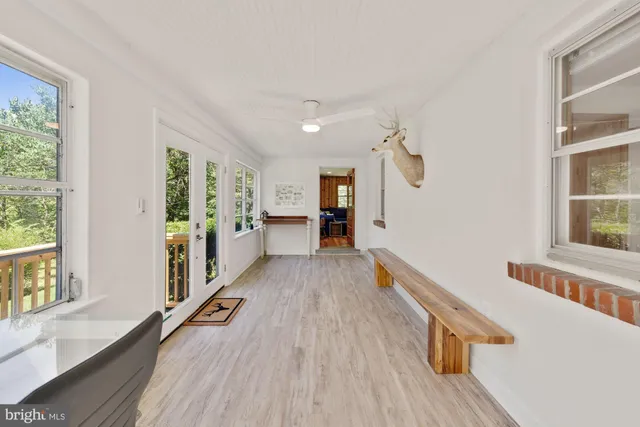 a view of a hallway with wooden floor and staircase
