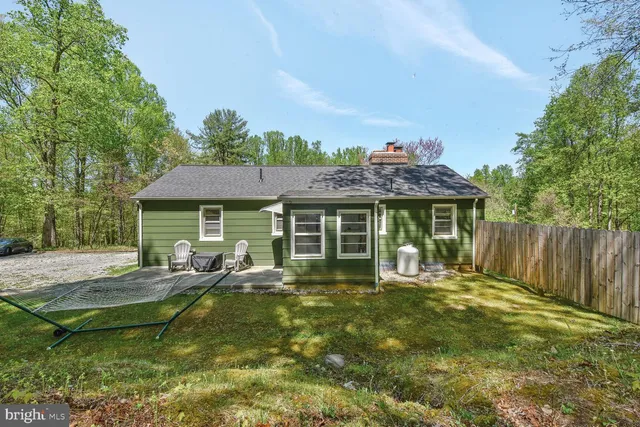 a view of an house with backyard space and balcony