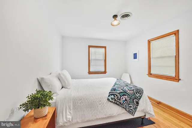 a bed sitting in a bedroom next to a window