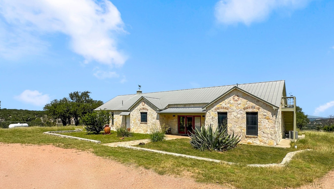 1428 Seven Spgs Drive Junction, TX 76849 - Photo 3 of 39 a view of house with garden and tall trees