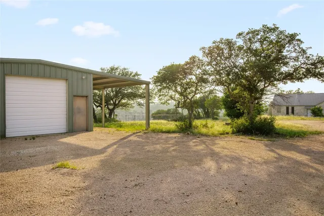 a view of a house with backyard and tree