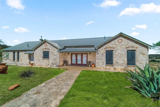 a front view of a house with a yard and porch