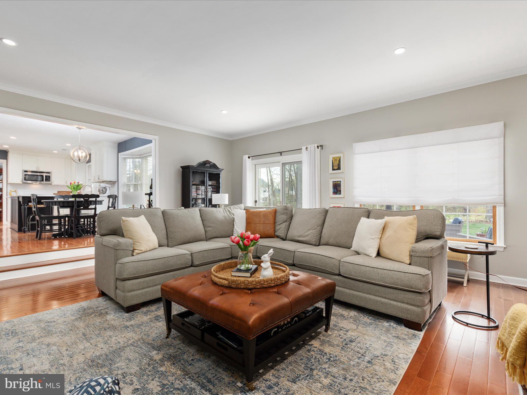 20299 Mustoe Place Ashburn, VA 20147 - Photo 16 of 45 a living room with furniture wooden floor and a large window