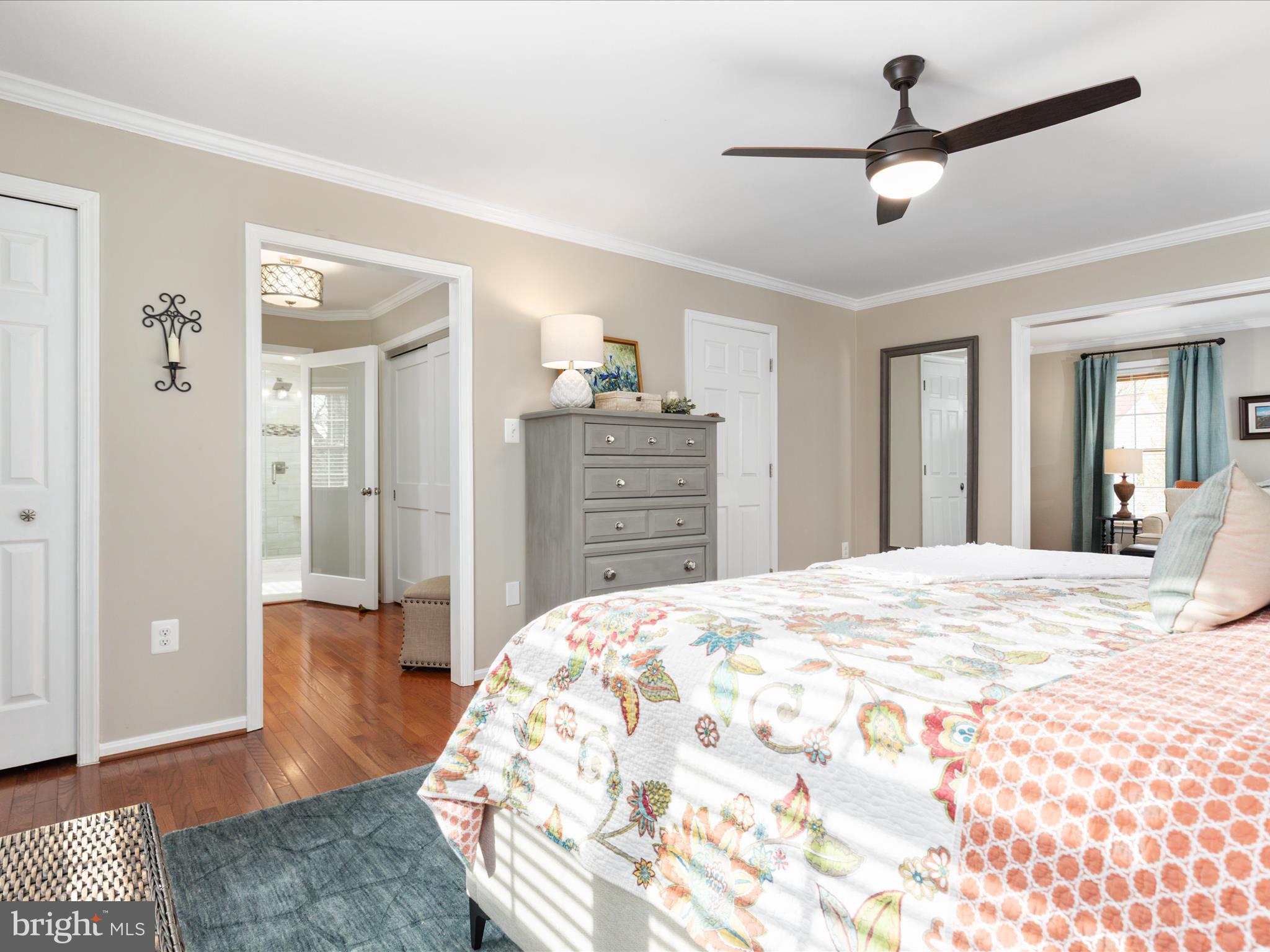 20299 Mustoe Place Ashburn, VA 20147 - Photo 19 of 45 a bedroom with a bed and a chandelier