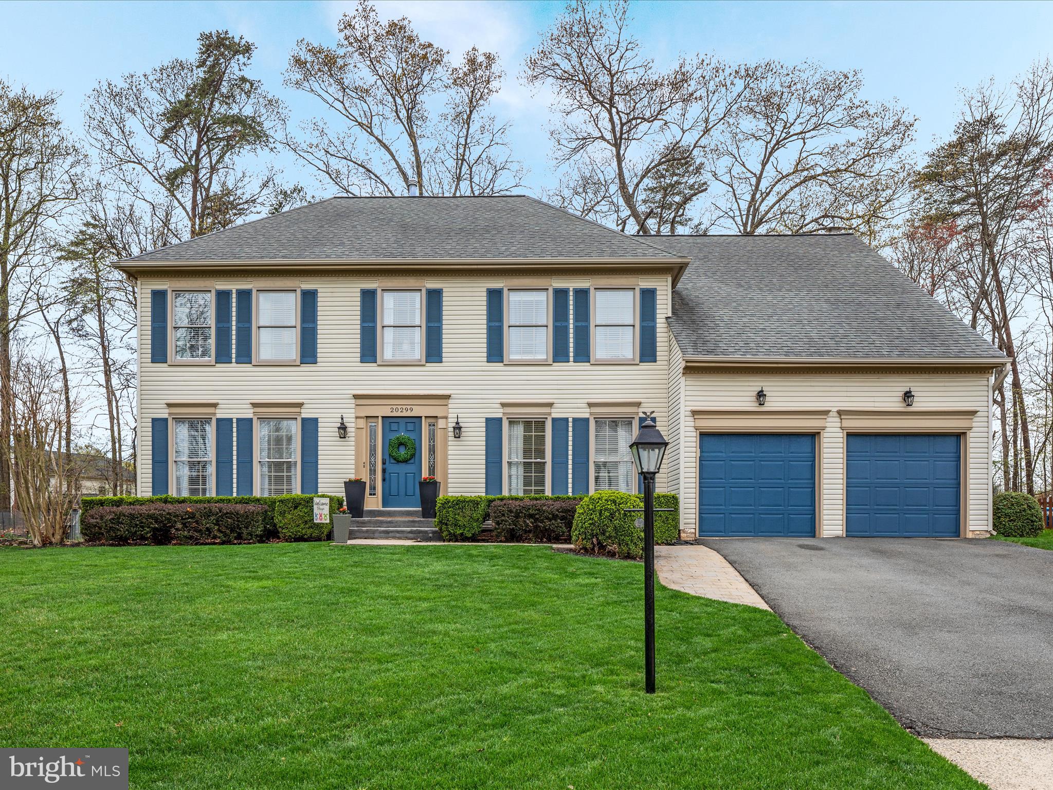 20299 Mustoe Place Ashburn, VA 20147 - Photo 2 of 45 a front view of a house with a garden and plants