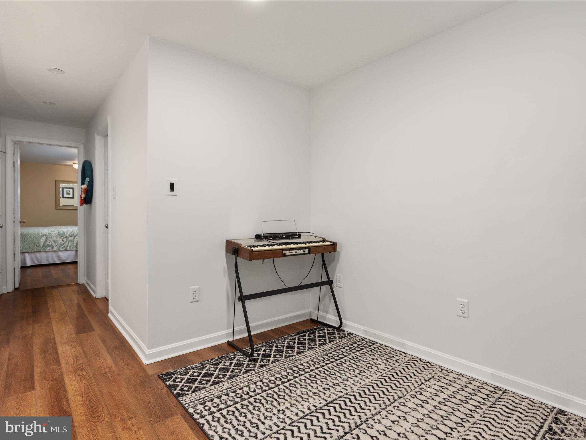 20299 Mustoe Place Ashburn, VA 20147 - Photo 31 of 45 a view of a room with wooden floor and a rug