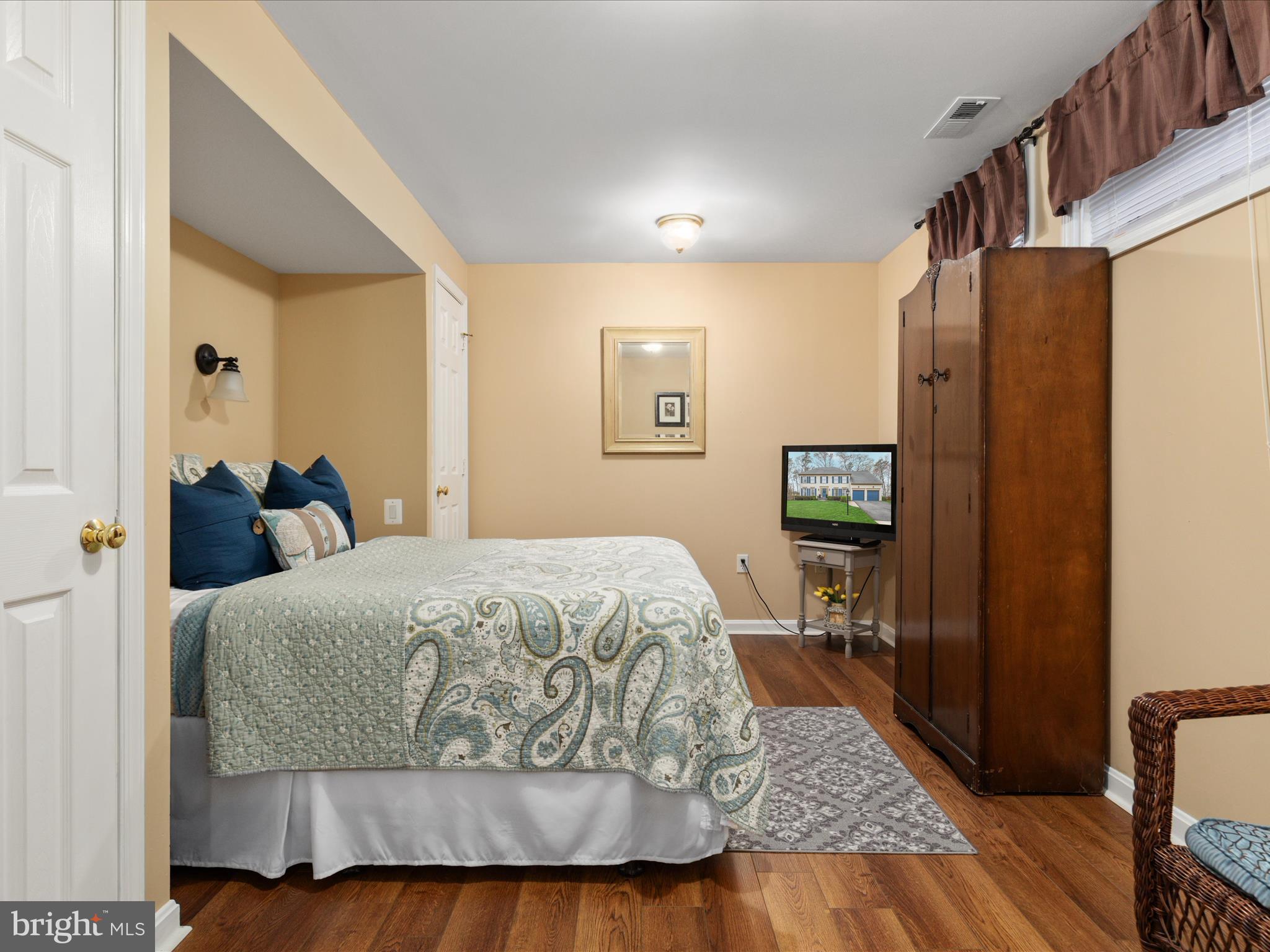 20299 Mustoe Place Ashburn, VA 20147 - Photo 32 of 45 a bedroom with a bed and wooden floor