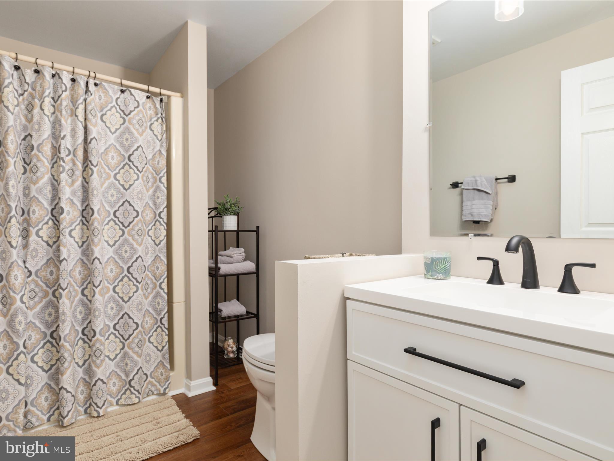 20299 Mustoe Place Ashburn, VA 20147 - Photo 33 of 45 a bathroom with a sink toilet and shower