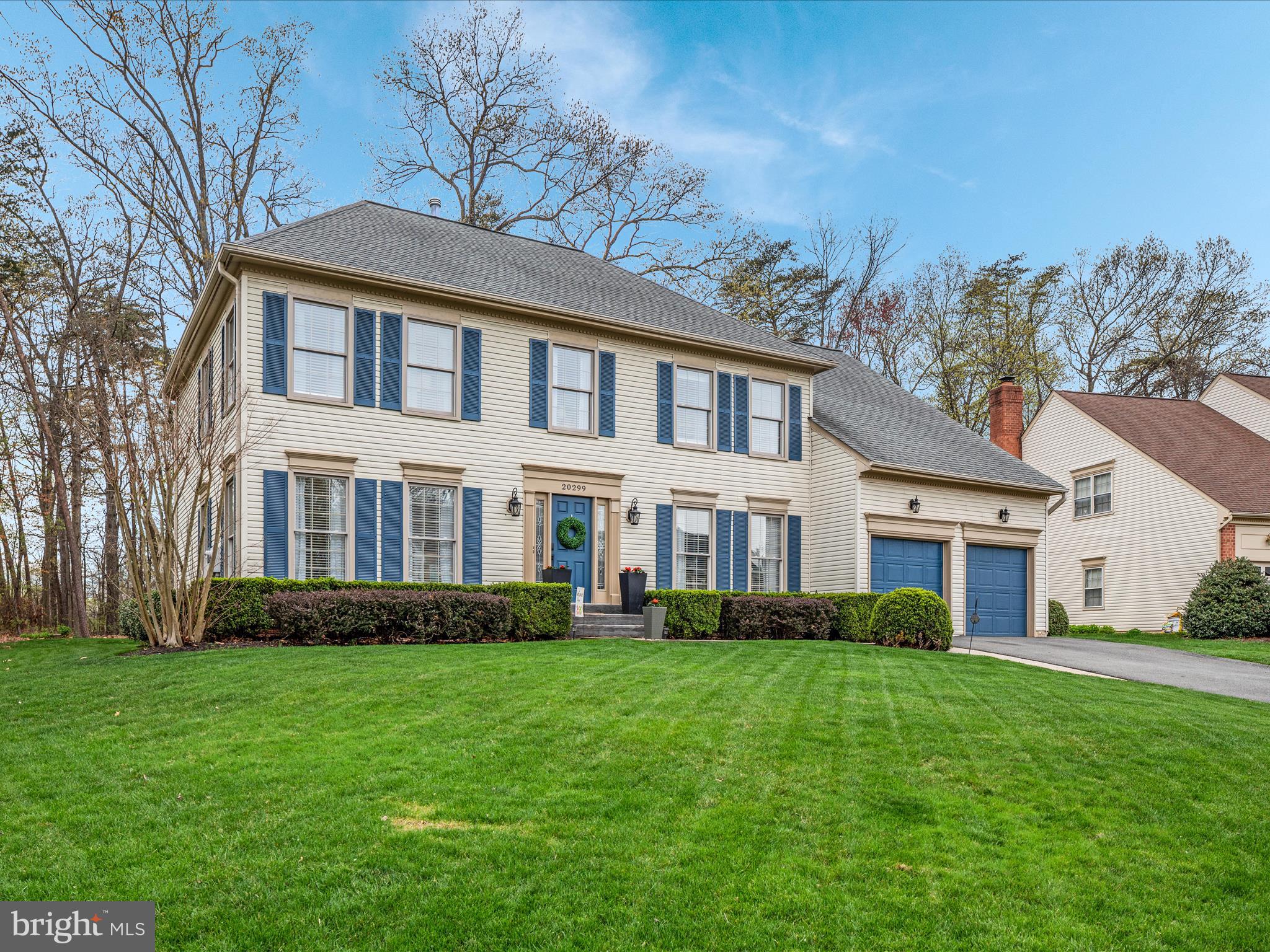 20299 Mustoe Place Ashburn, VA 20147 - Photo 34 of 45 a front view of a house with a garden