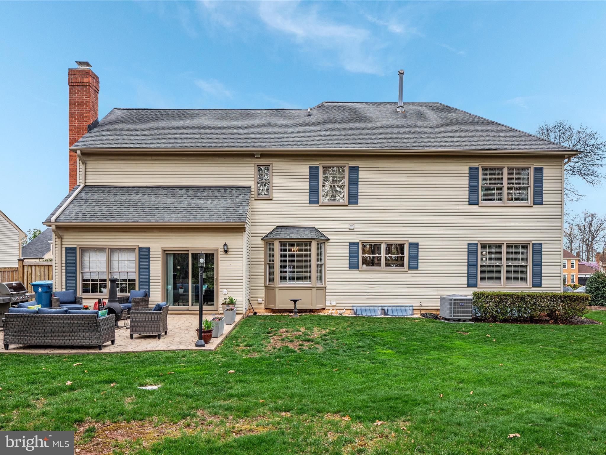 20299 Mustoe Place Ashburn, VA 20147 - Photo 36 of 45 a front view of a house with a yard and outdoor seating