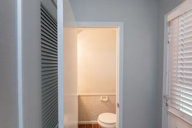 a view of a room with wooden floor and chandelier