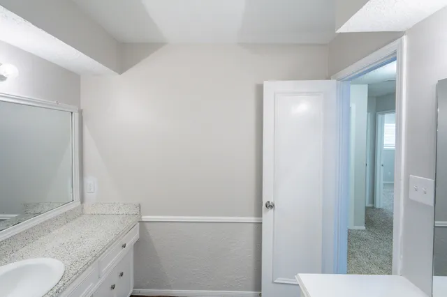 a bathroom with a window a shower and a toilet