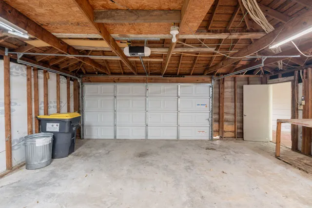 a view of a house with a yard and a large tree