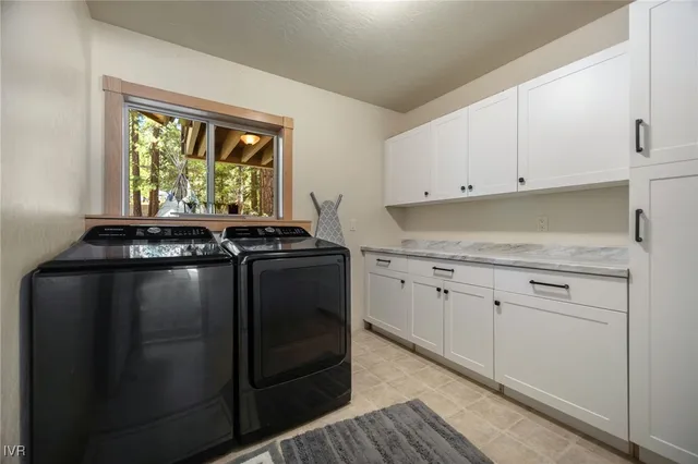 a kitchen with granite countertop white cabinets and black appliances