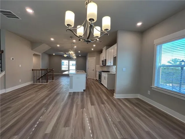 a view of a room with wooden floor