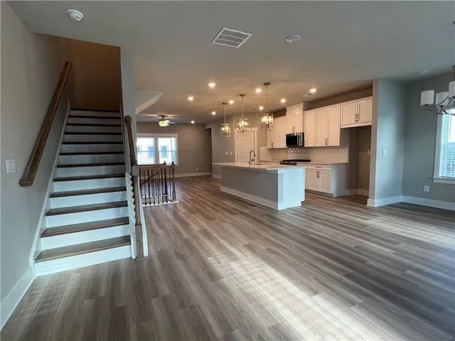 a view of a kitchen with cabinets and wooden floor