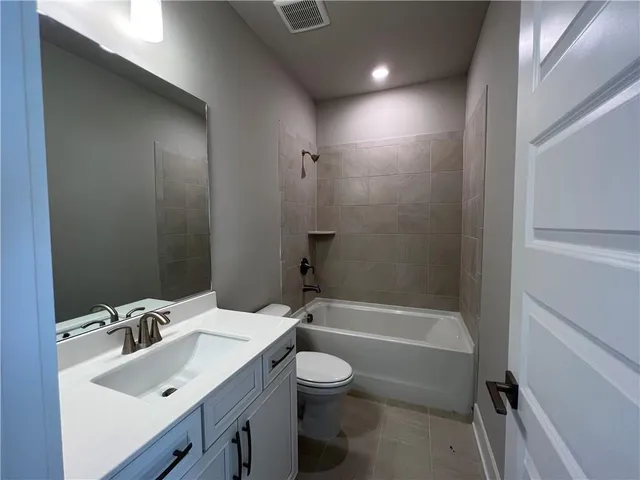 a bathroom with a sink toilet tub and shower